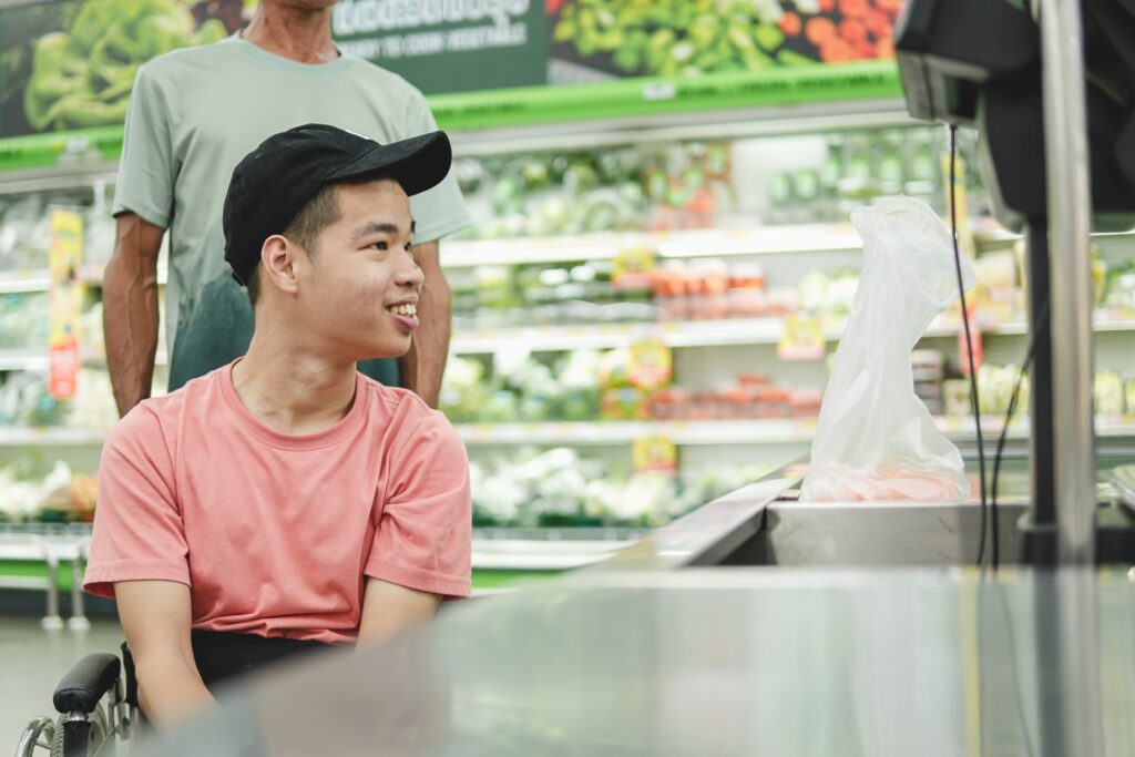 Disabled man in wheelchair at grocery store