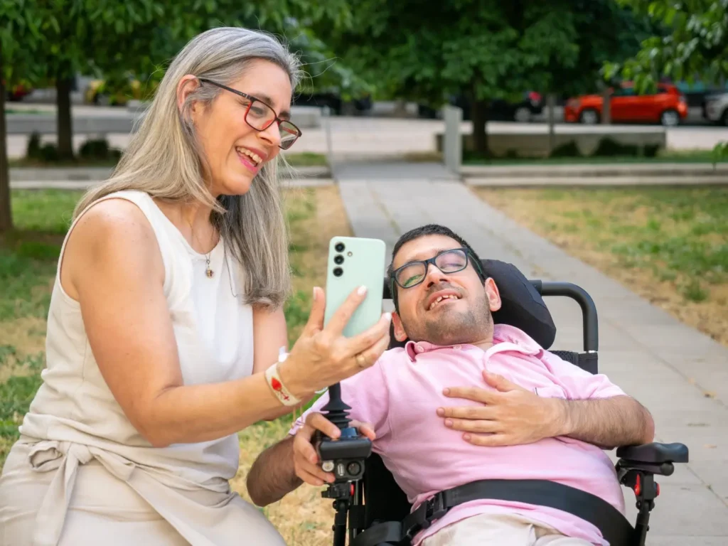 Support worker on video call with disabled man