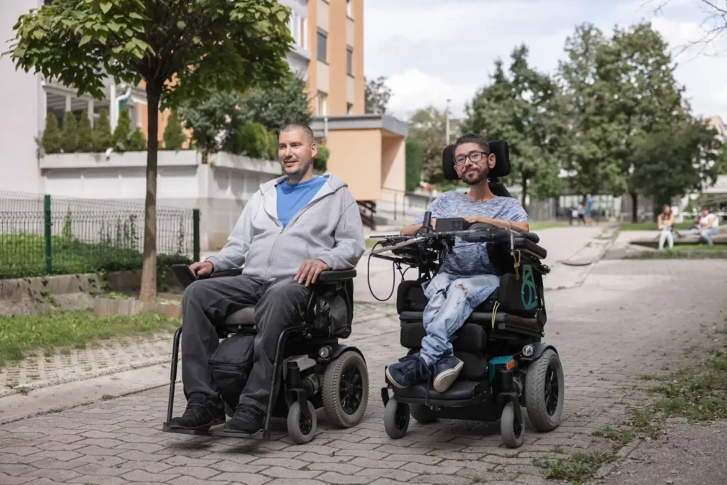Two disabled friends in wheelchairs