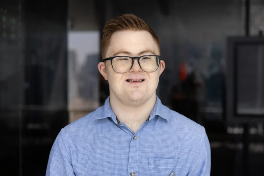 Disabled man with down syndrome smiling at camera